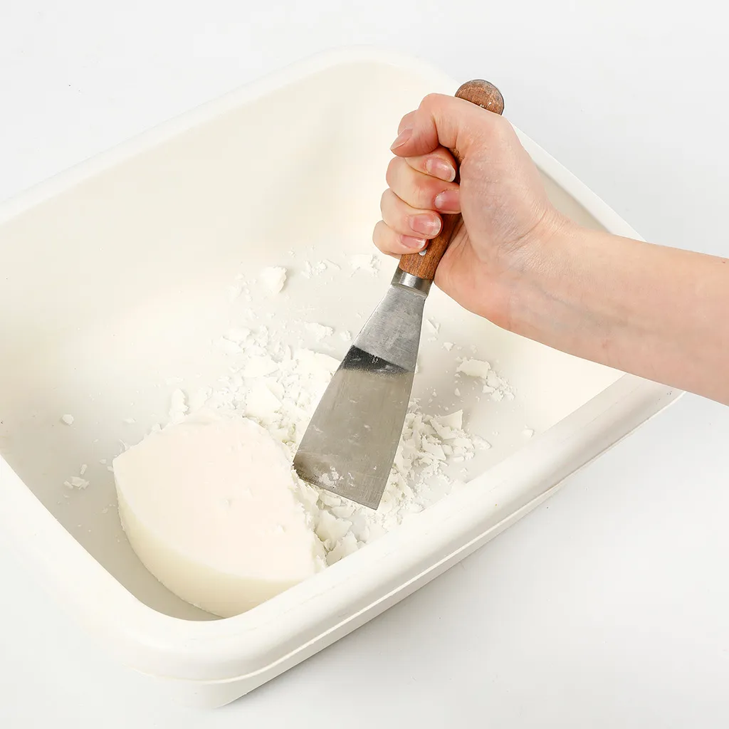 blok was wordt in stukken gehakt met een paletmes